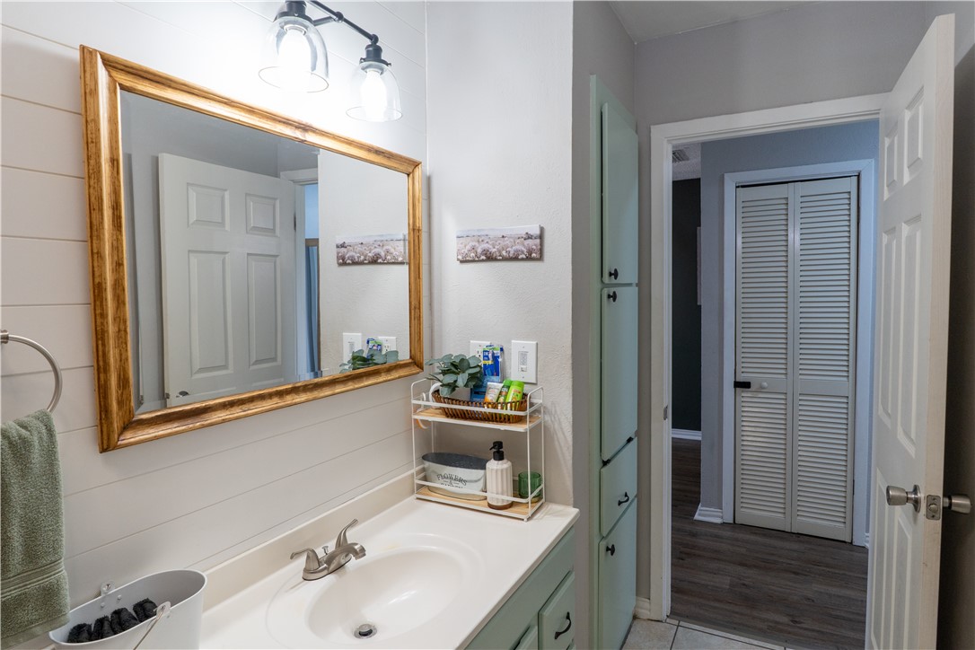 6107 Hidden Wood Corpus Christi, TX 78412 - Photo 7 of 9 a bathroom with a sink and a mirror