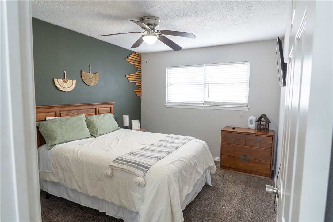 6107 Hidden Wood Corpus Christi, TX 78412 - Photo 8 of 9 a bedroom with a bed and a window