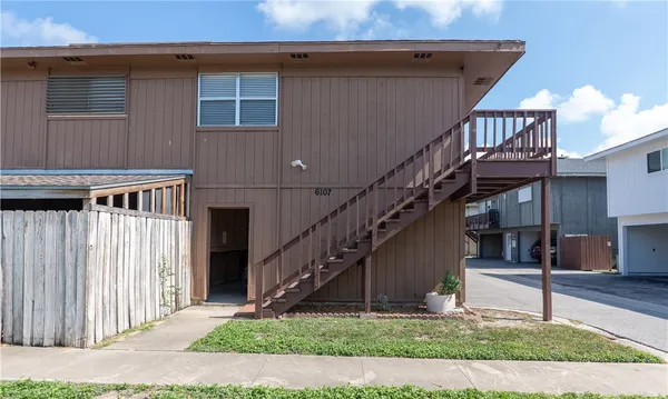 a front view of a house with wooden stairs