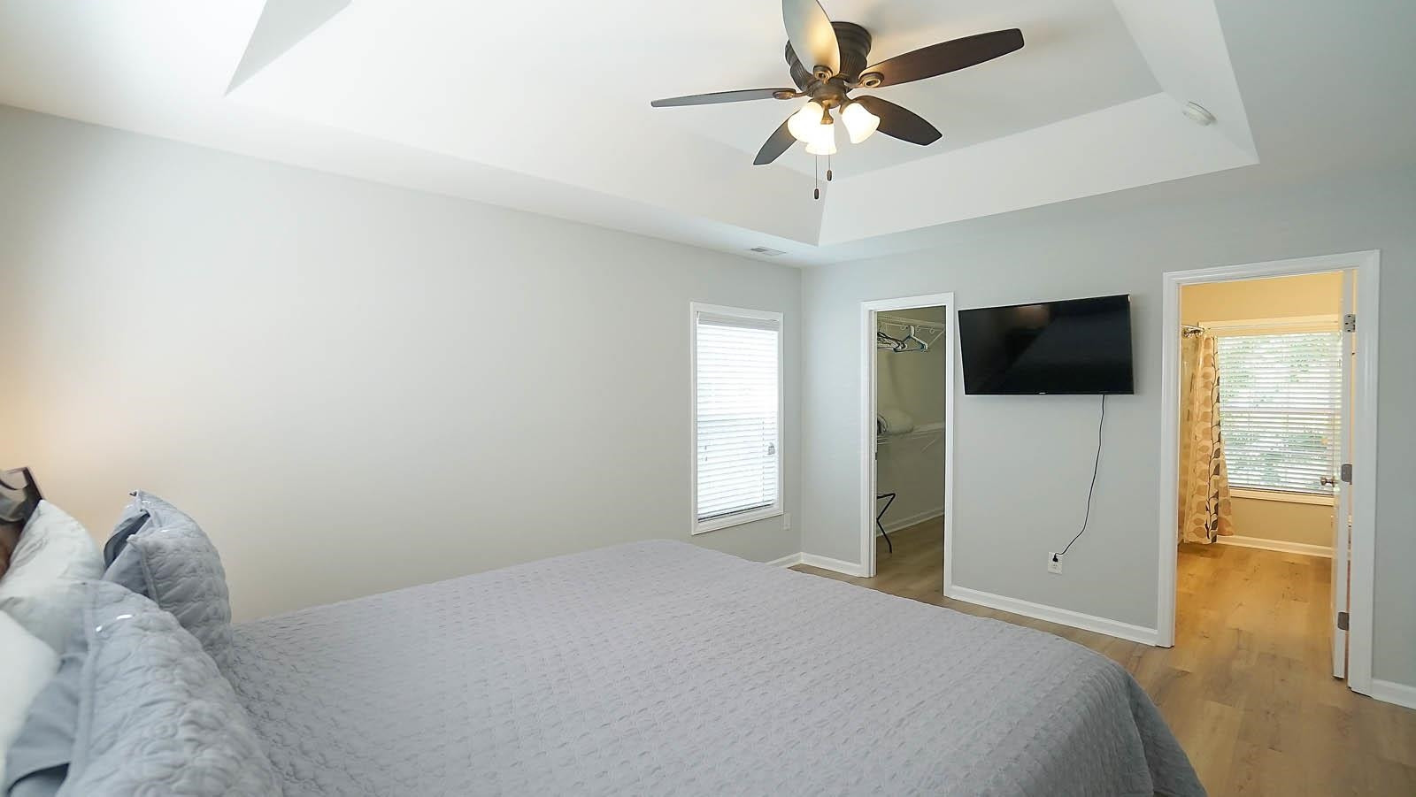 4305 Chimney Stone Road Durham, NC 27704 - Photo 11 of 21 a bedroom with a bed and a flat tv screen on the dresser