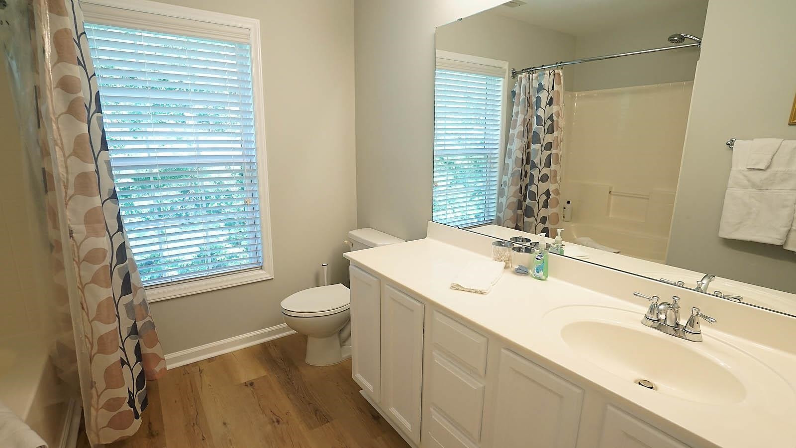 4305 Chimney Stone Road Durham, NC 27704 - Photo 12 of 21 a bathroom with a granite countertop sink toilet and shower