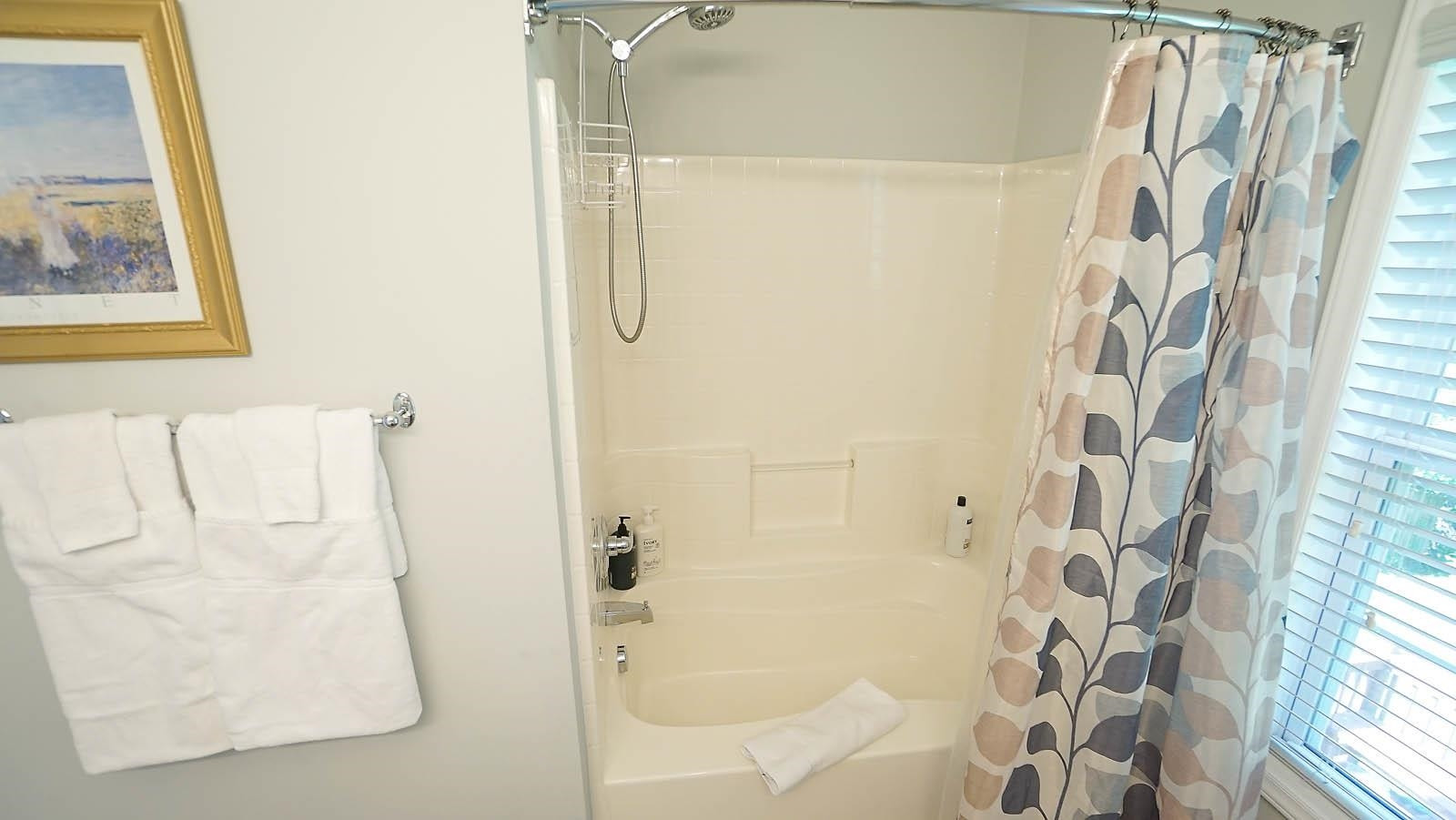 4305 Chimney Stone Road Durham, NC 27704 - Photo 13 of 21 a bathroom with a shower curtain