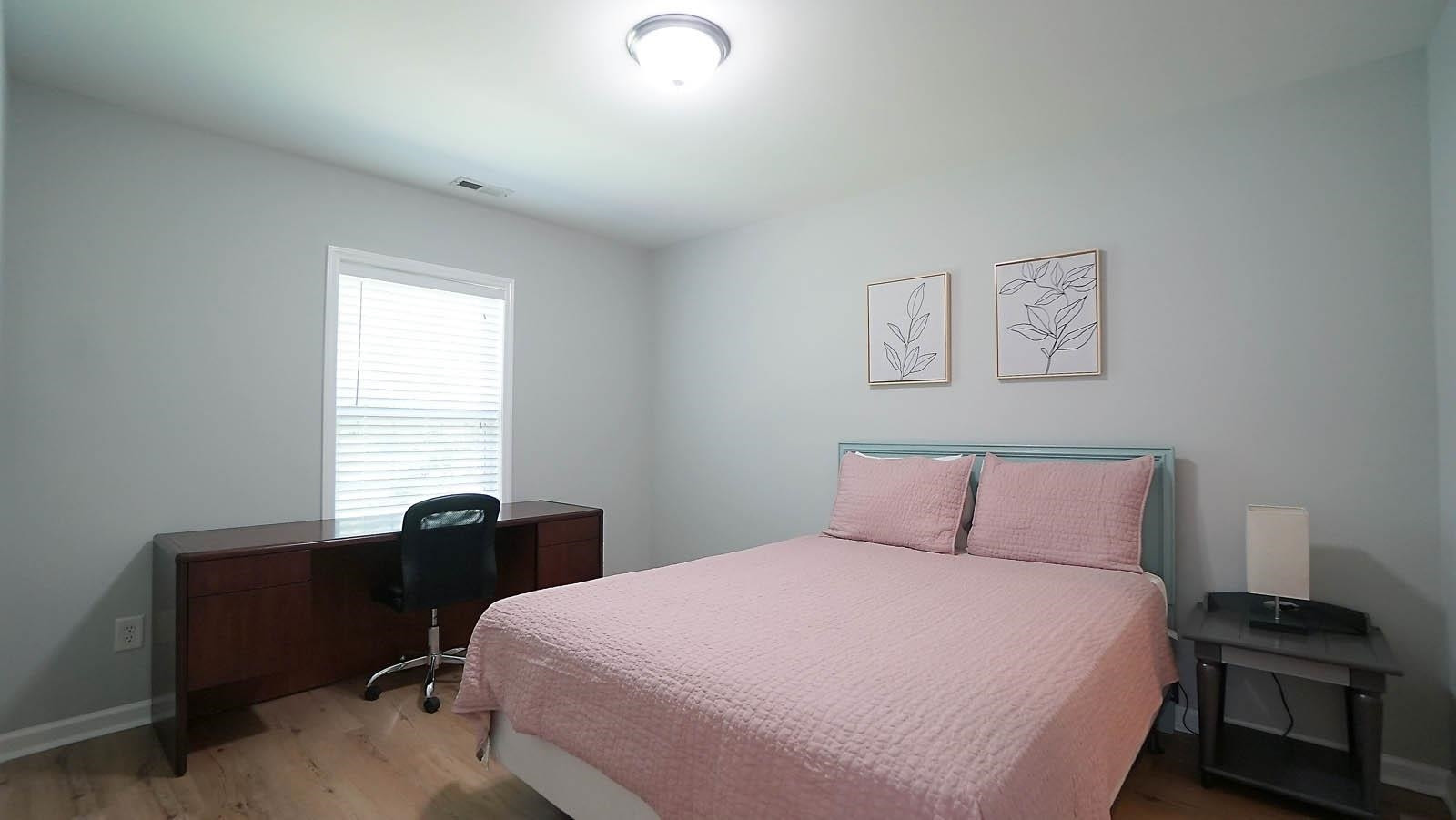 4305 Chimney Stone Road Durham, NC 27704 - Photo 15 of 21 a bedroom with a bed and a desk