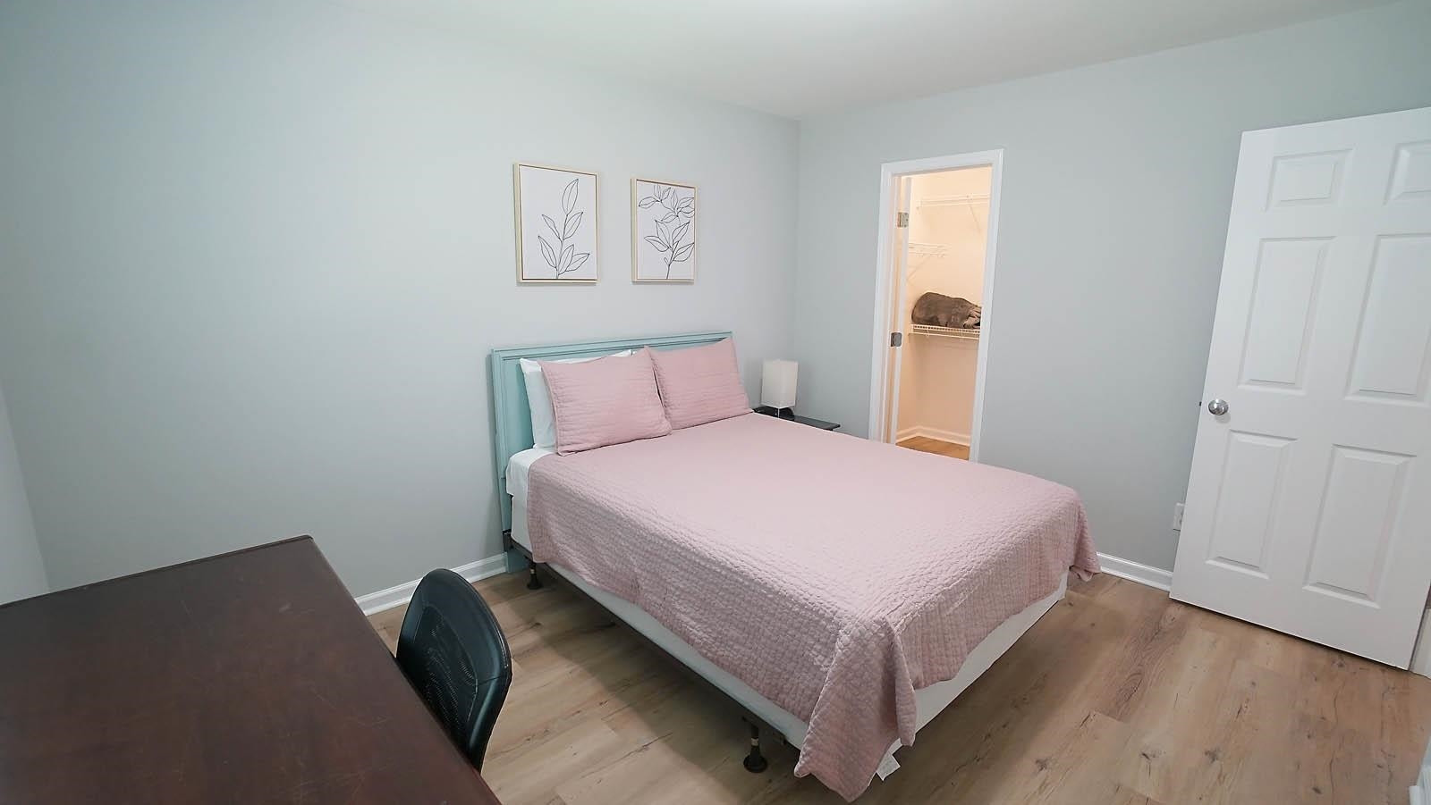 4305 Chimney Stone Road Durham, NC 27704 - Photo 16 of 21 a bed room with a bed and a night stand