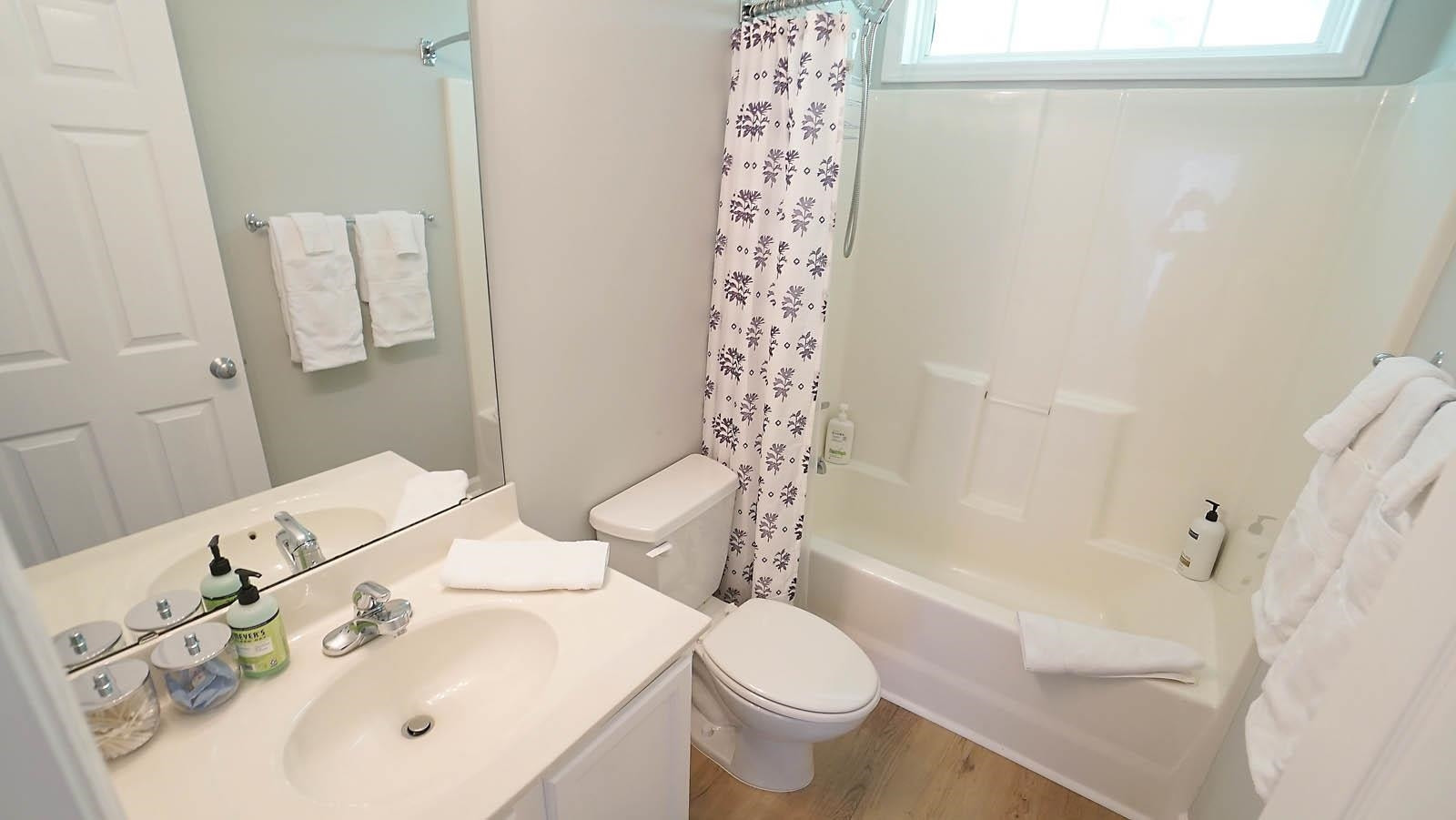 4305 Chimney Stone Road Durham, NC 27704 - Photo 18 of 21 a bathroom with a sink toilet and shower