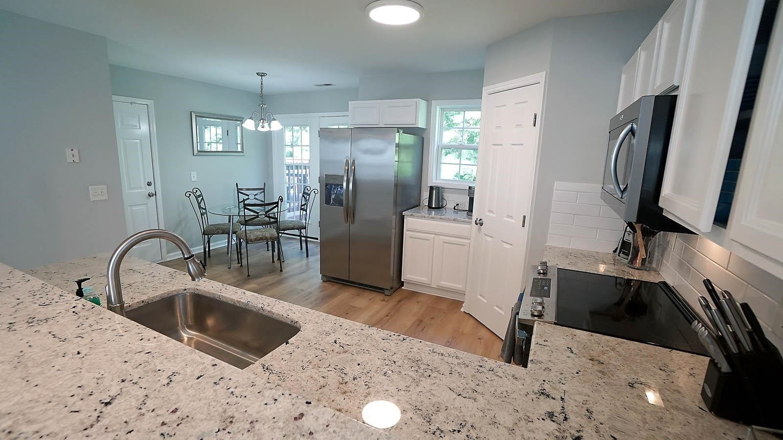 4305 Chimney Stone Road Durham, NC 27704 - Photo 6 of 21 a kitchen with a sink appliances and a counter top space