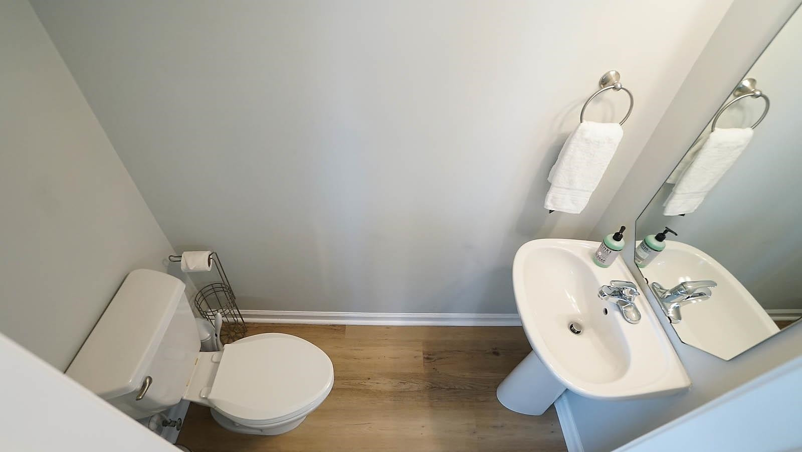 4305 Chimney Stone Road Durham, NC 27704 - Photo 9 of 21 a bathroom with a toilet mirror and sink