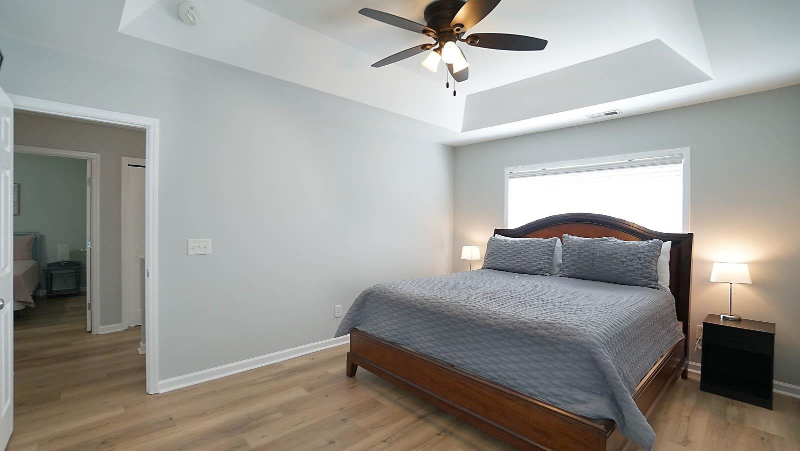 4305 Chimney Stone Road Durham, NC 27704 - Photo 10 of 21 a bedroom with a bed and a chandelier