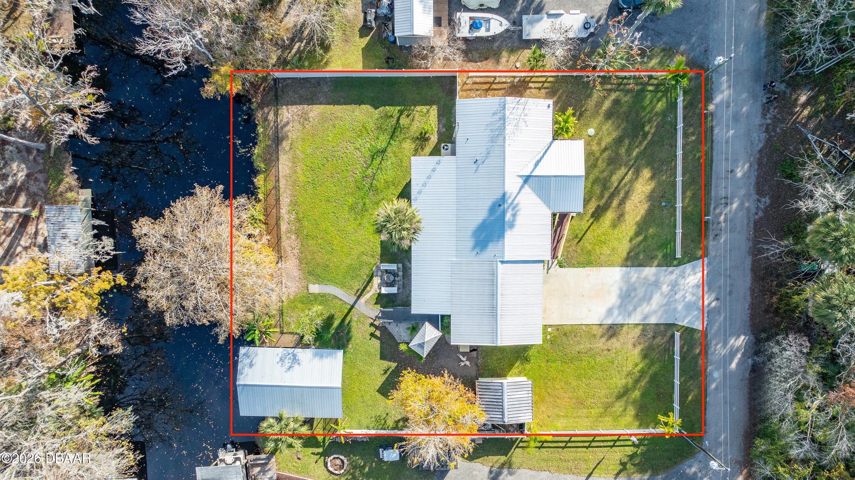56320 Cherry Tree Road Astor, FL 32102 - Photo 22 of 39 an aerial view of a swimming pool with outdoor seating and yard