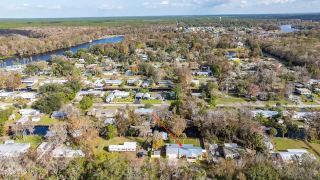 a view of a table and chairs in backyard of the house