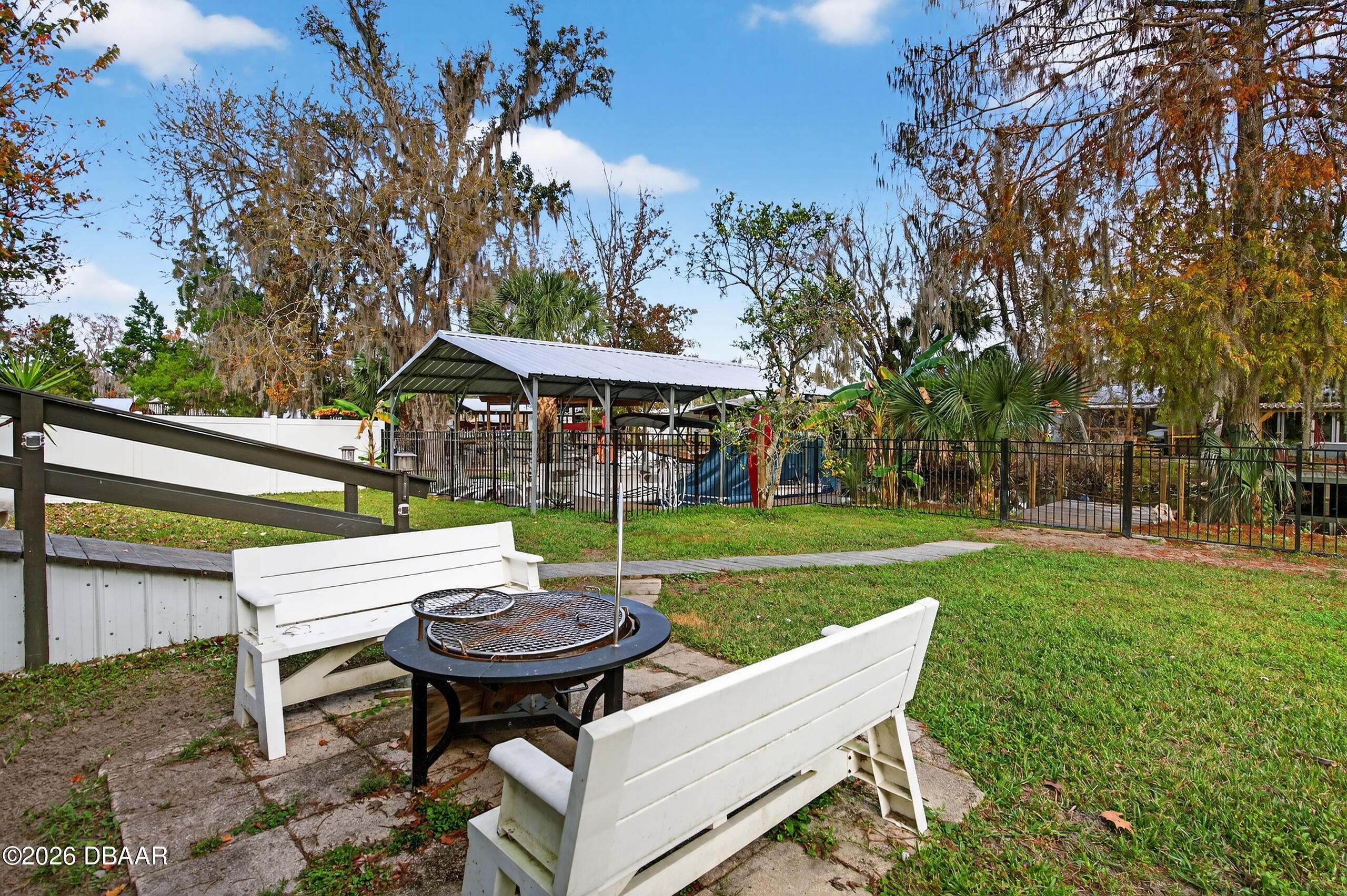 56320 Cherry Tree Road Astor, FL 32102 - Photo 34 of 39 a view of a table and chairs in backyard of the house