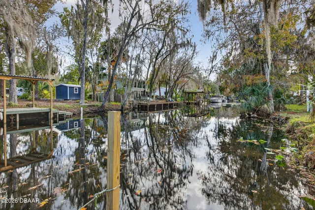 a living room with furniture a flat screen tv and a window