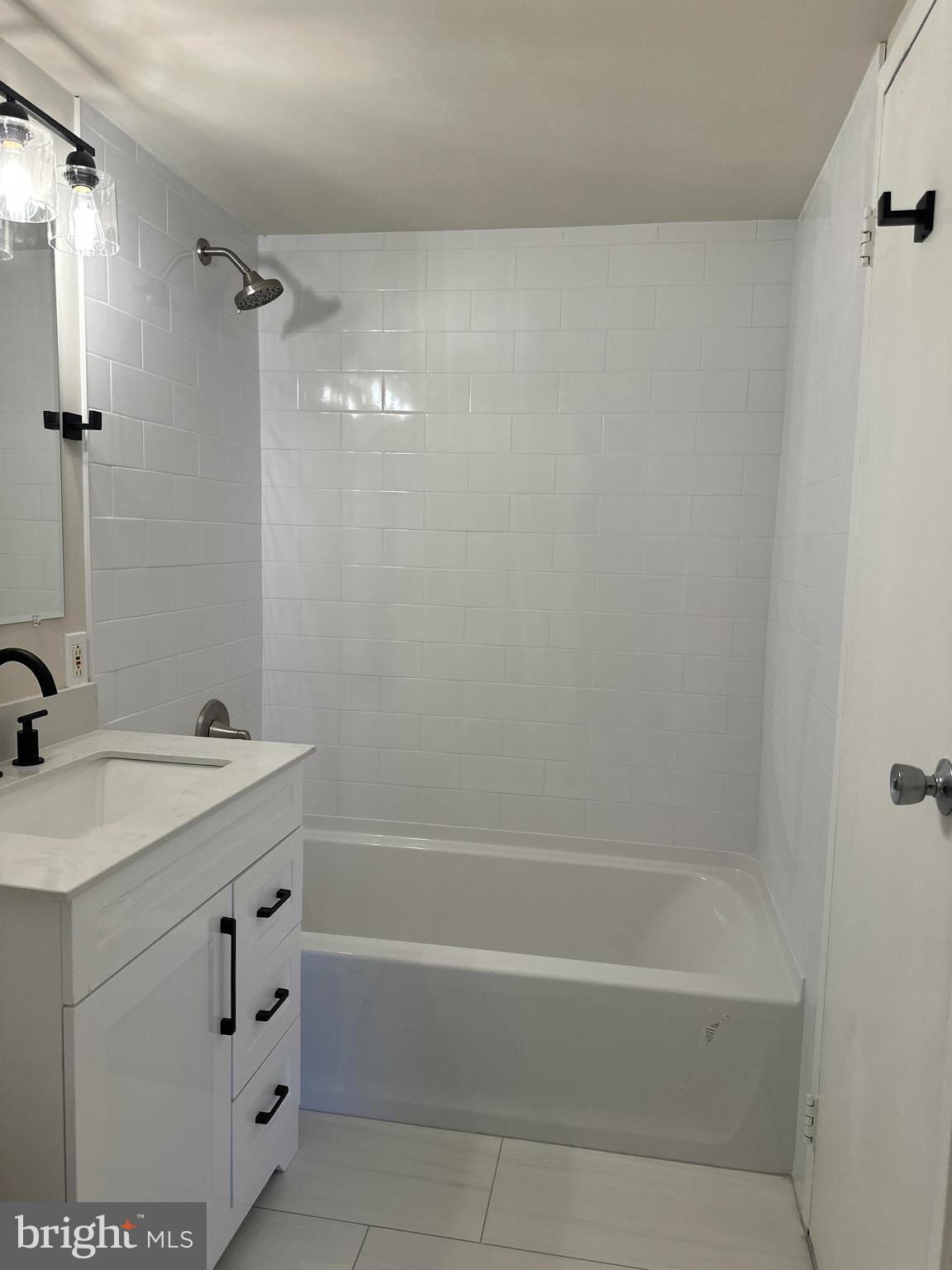2317 Freetown Court, Unit 11C Reston, VA 20191 - Photo 12 of 21 a bathroom with a sink a mirror and a bathtub