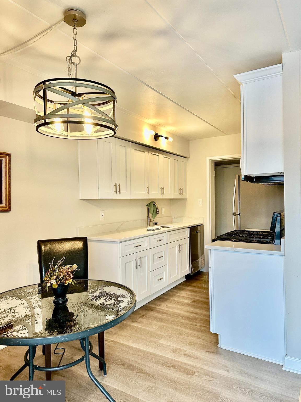 2317 Freetown Court, Unit 11C Reston, VA 20191 - Photo 4 of 21 a kitchen with sink cabinets and dining table
