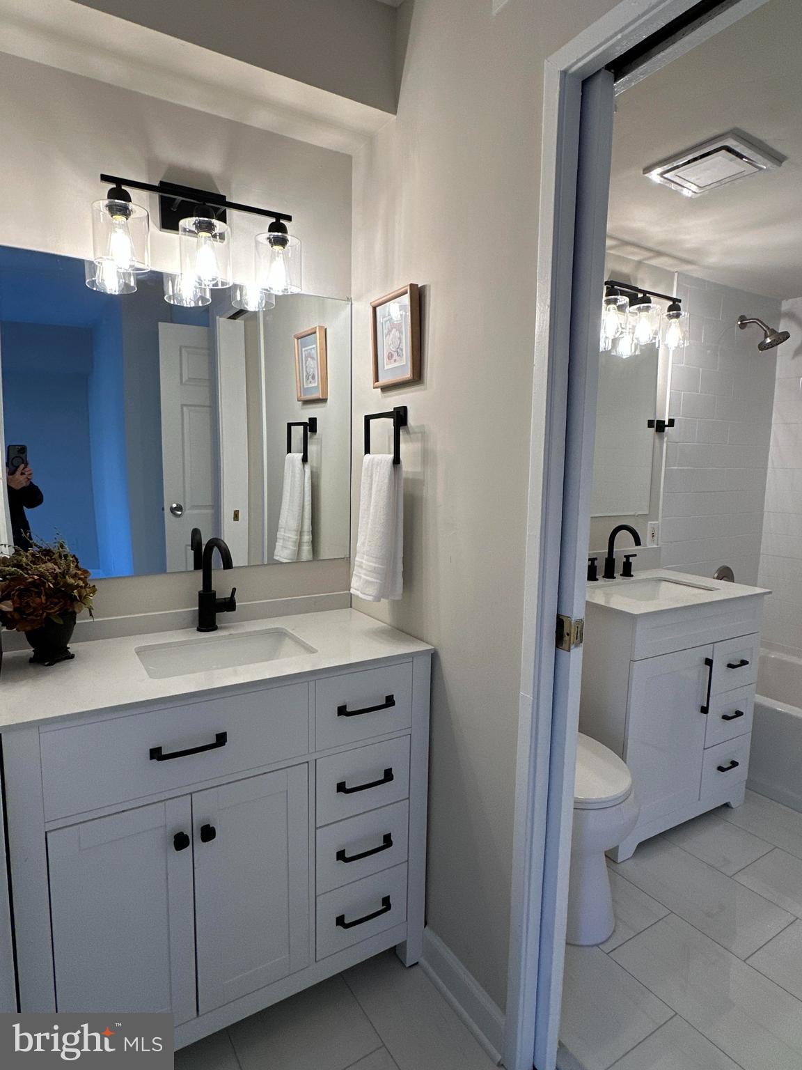 2317 Freetown Court, Unit 11C Reston, VA 20191 - Photo 10 of 21 a bathroom with a double vanity sink and a mirror