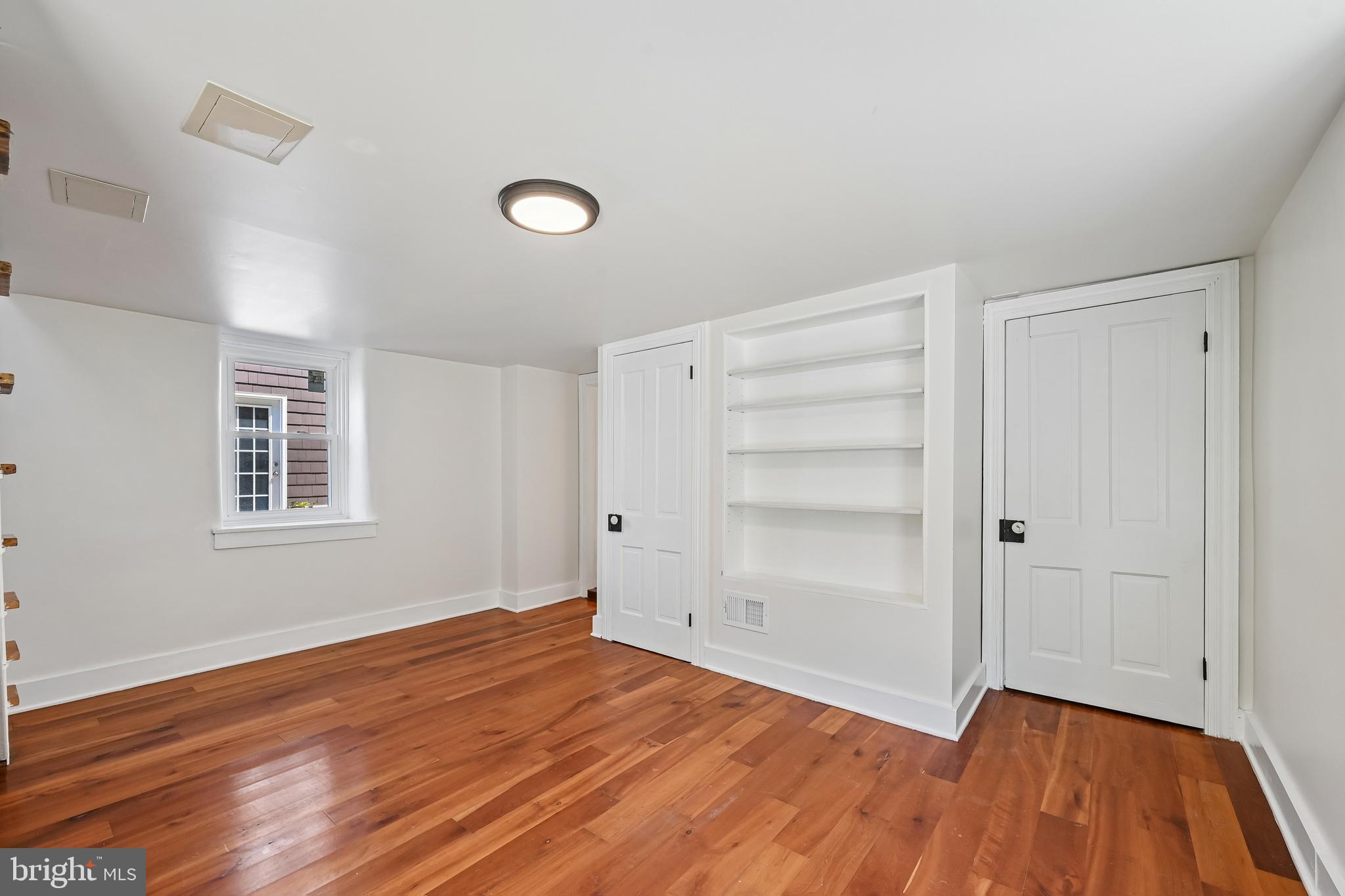 5702 Falls Road Baltimore, MD 21209 - Photo 21 of 49 wooden floor in an empty room with a window