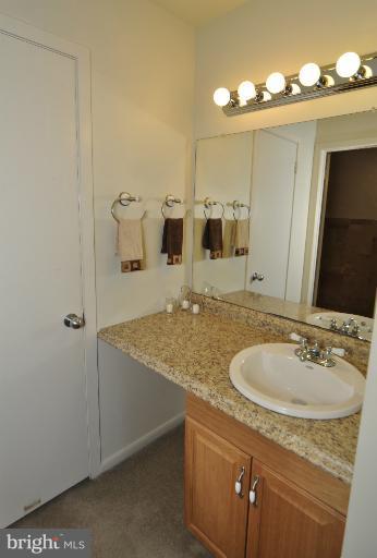 11206 Lagoon Lane Reston, VA 20191 - Photo 10 of 27 a bathroom with a granite countertop sink and a mirror