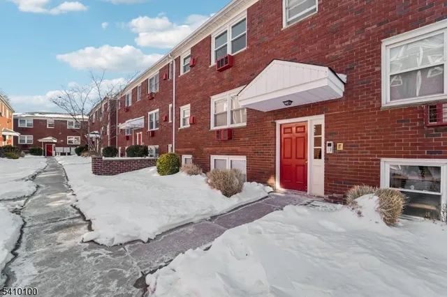a view of a building with cars on road