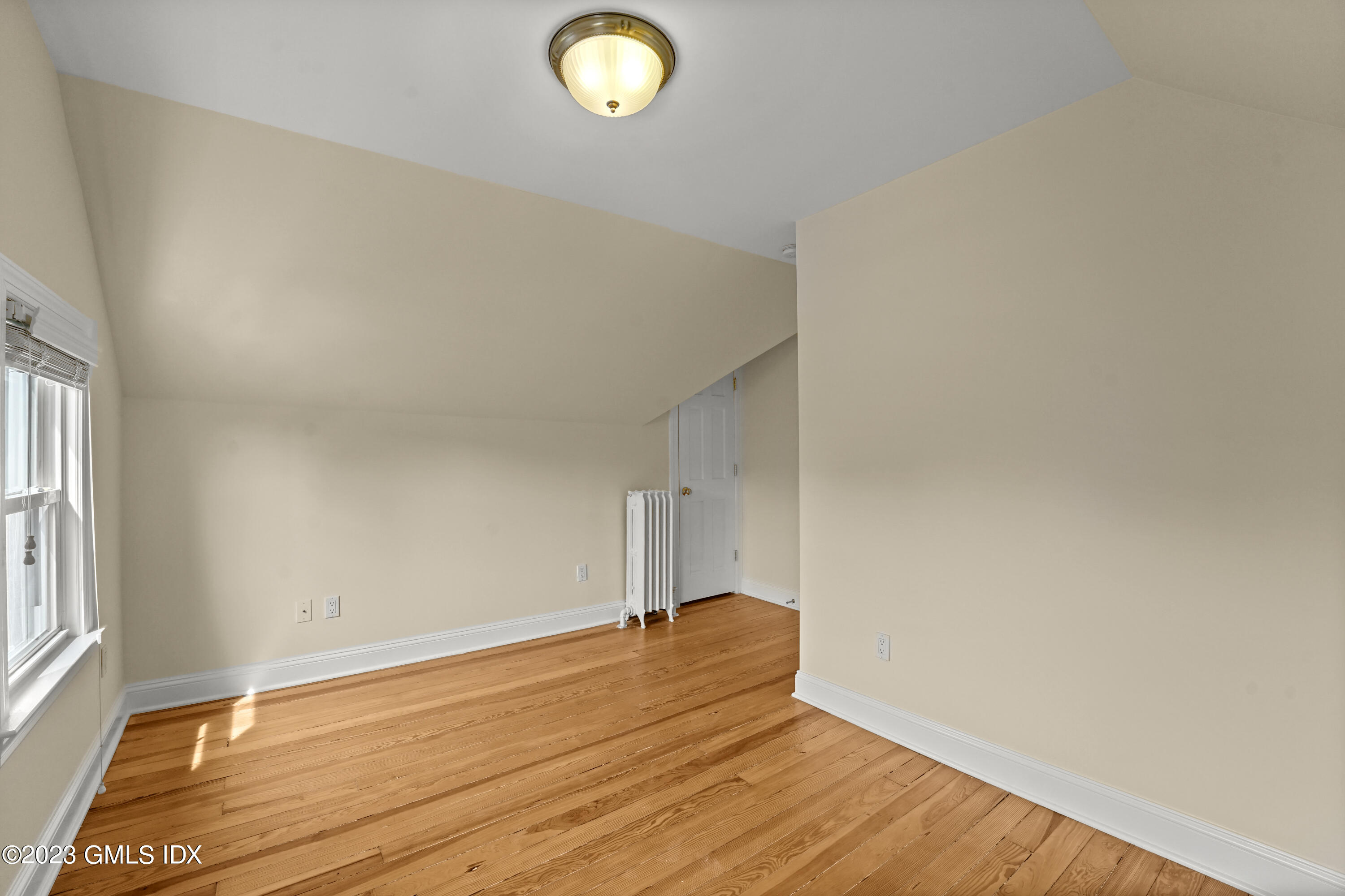 59 Ridge Street, Unit 2 Greenwich, CT 06830 - Photo 22 of 31 a view of a room with wooden floor and a window