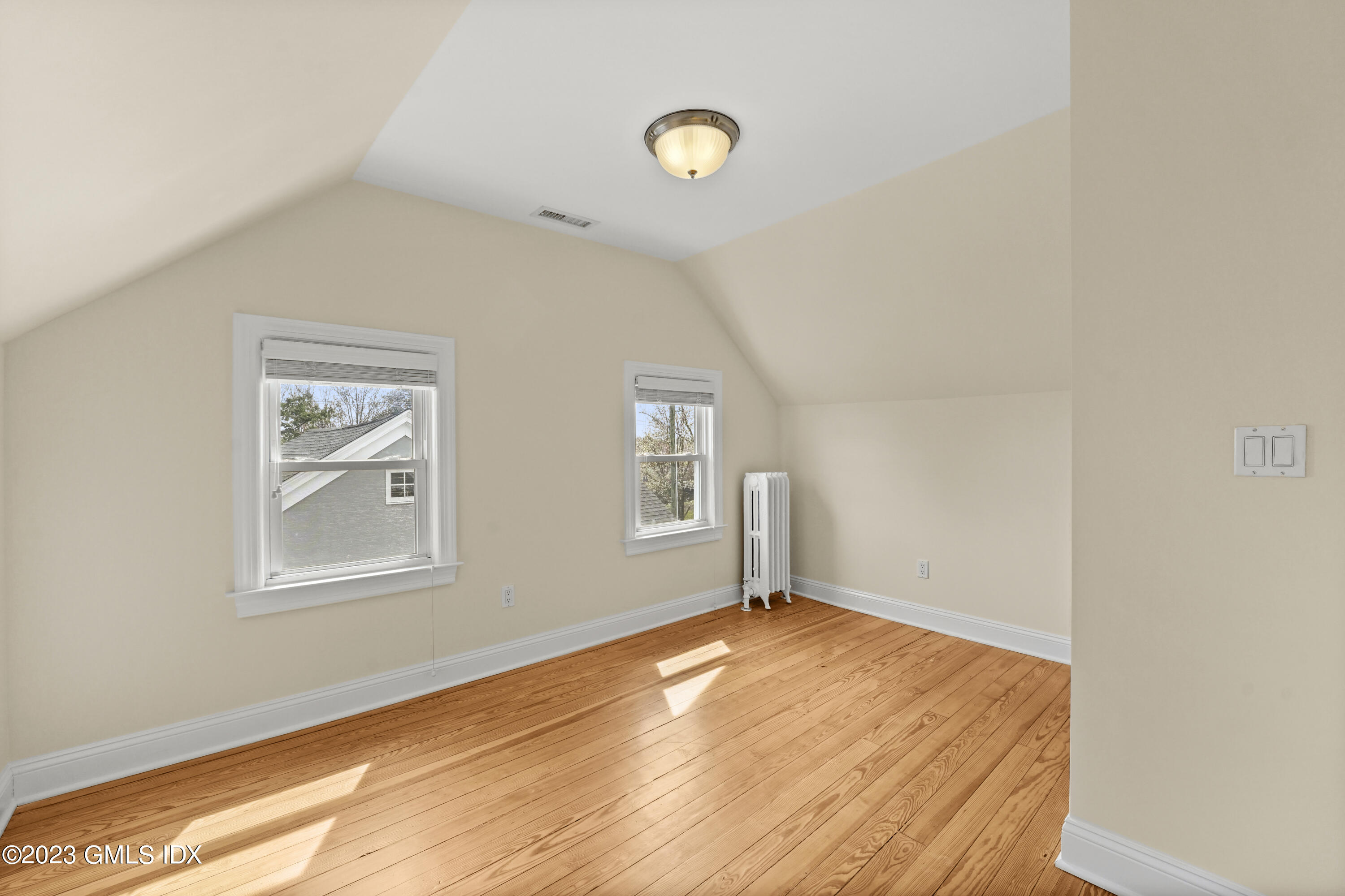 59 Ridge Street, Unit 2 Greenwich, CT 06830 - Photo 24 of 31 a view of a big room with wooden floor and windows