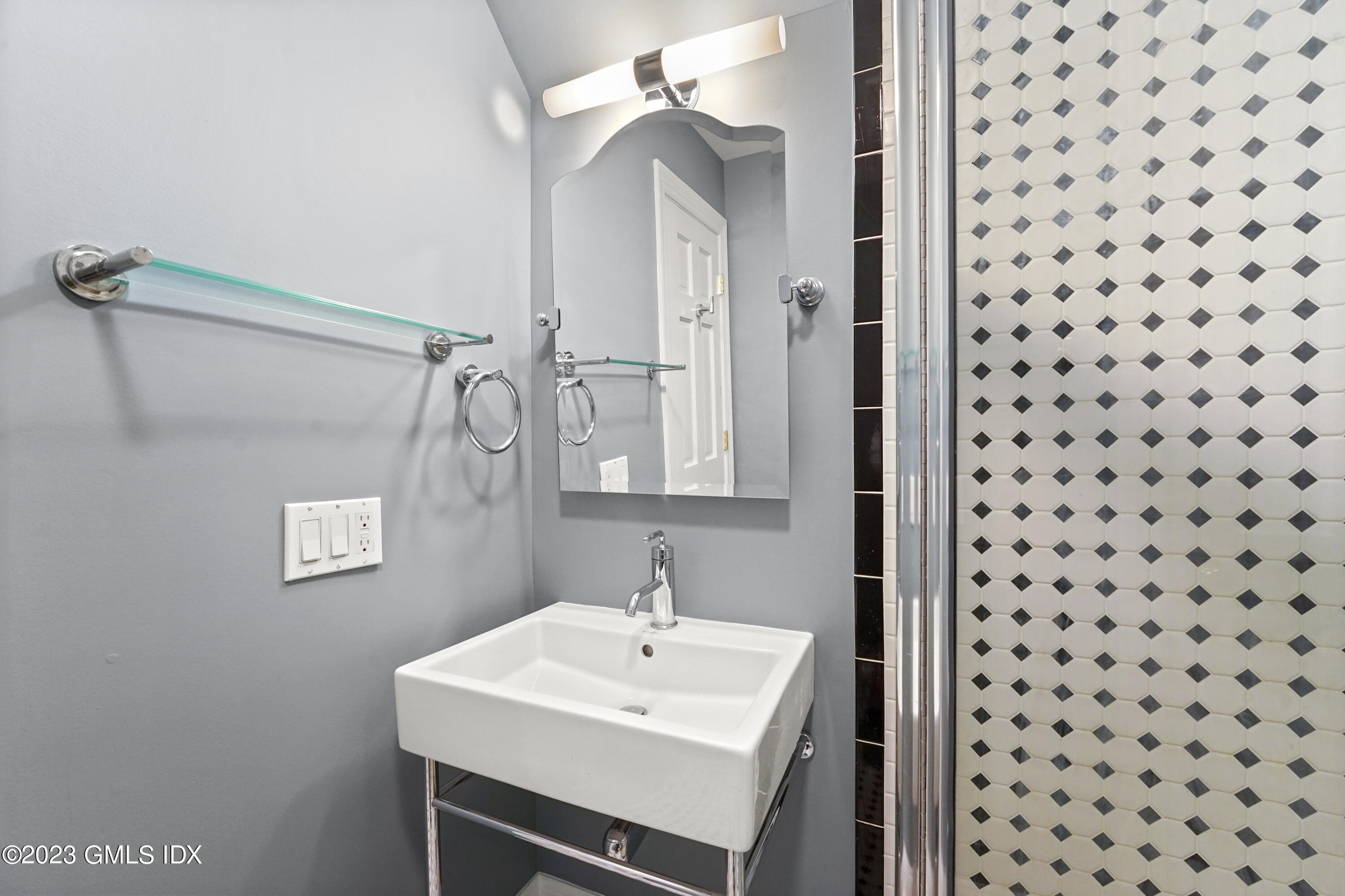 59 Ridge Street, Unit 2 Greenwich, CT 06830 - Photo 27 of 31 a bathroom with a sink a mirror and a shower