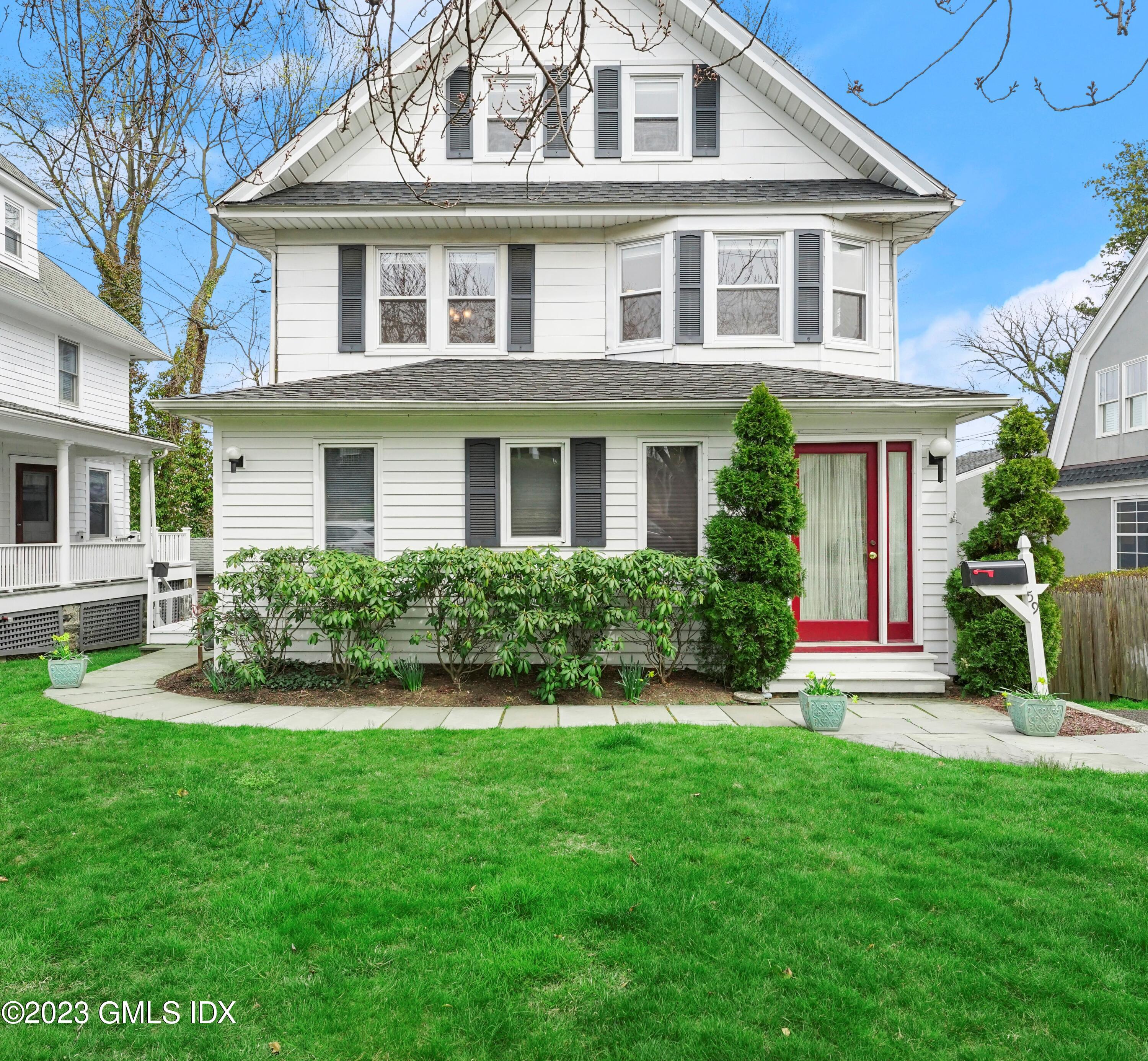 59 Ridge Street, Unit 2 Greenwich, CT 06830 - Photo 3 of 31 a front view of a house with a yard and porch