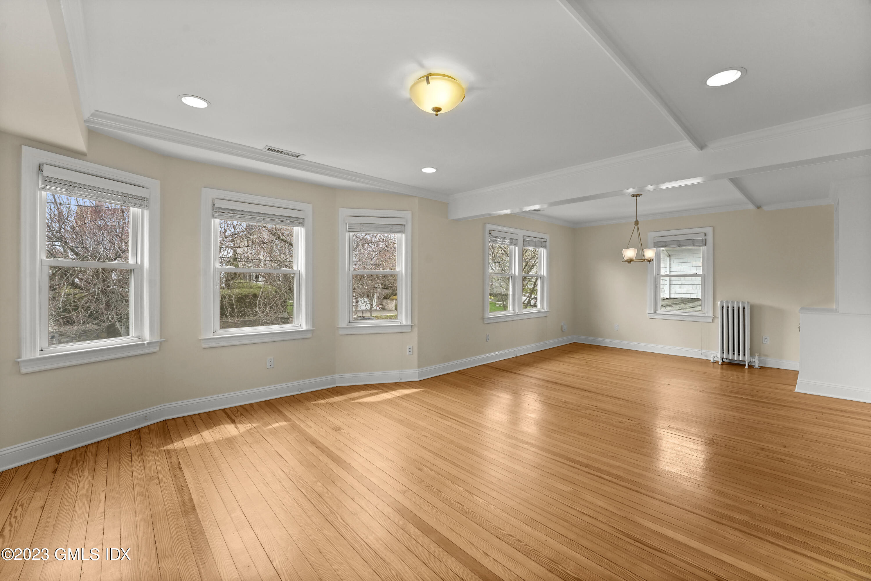 59 Ridge Street, Unit 2 Greenwich, CT 06830 - Photo 6 of 31 a view of an empty room with wooden floor and a window