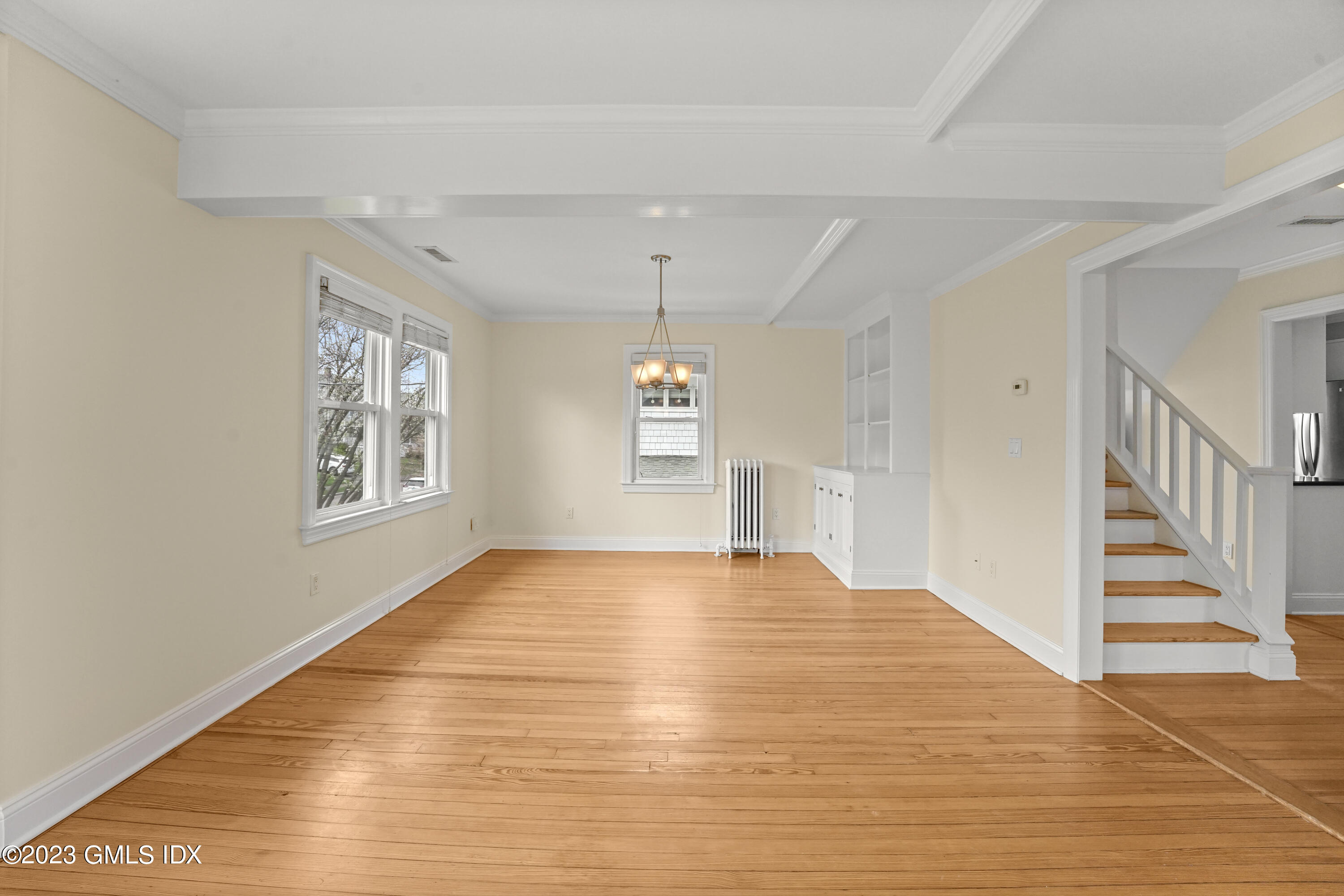 59 Ridge Street, Unit 2 Greenwich, CT 06830 - Photo 7 of 31 a view of an empty room with wooden floor and a window