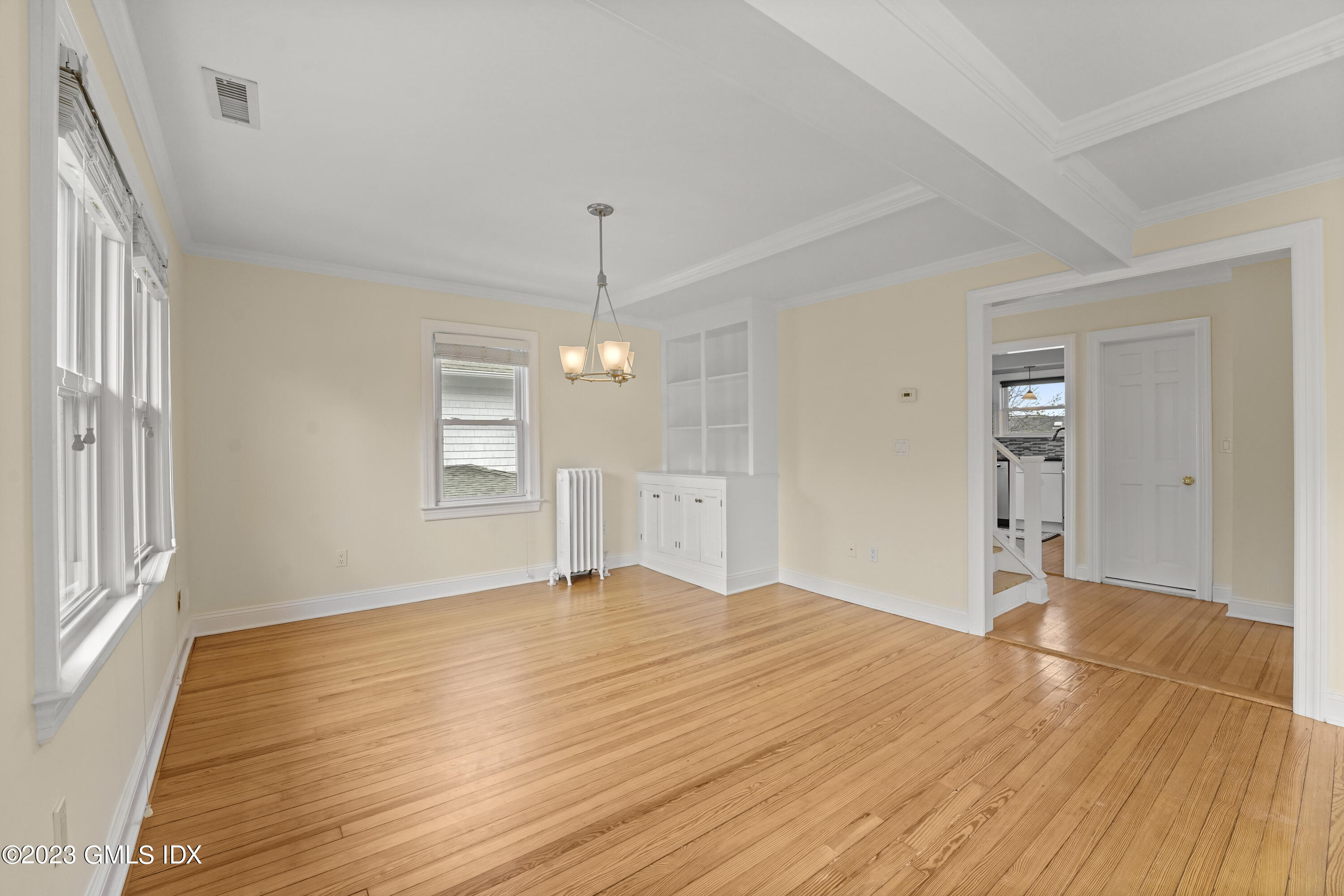 59 Ridge Street, Unit 2 Greenwich, CT 06830 - Photo 8 of 31 a view of an empty room with wooden floor kitchen view and a window