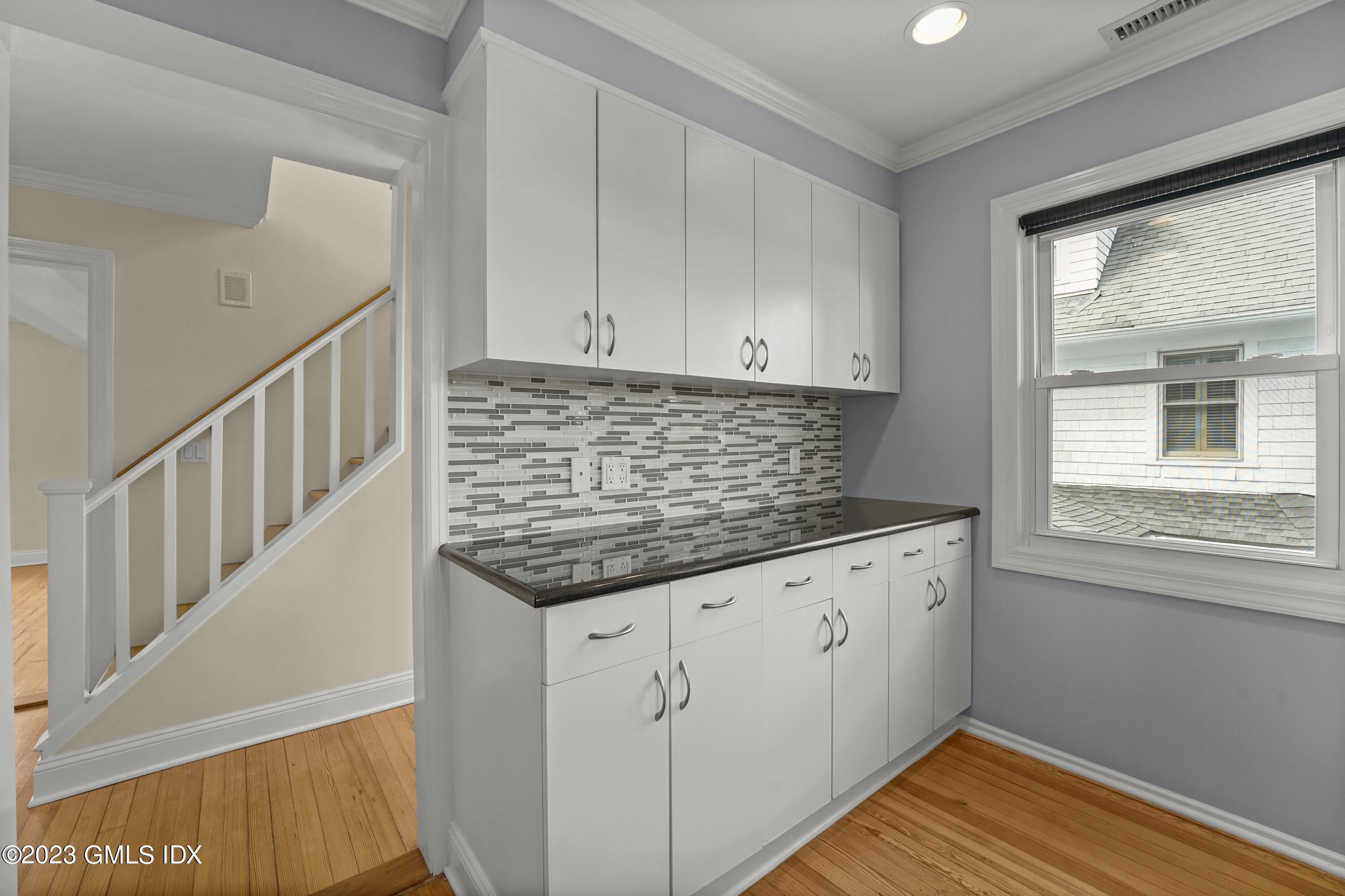 59 Ridge Street, Unit 2 Greenwich, CT 06830 - Photo 9 of 31 a kitchen with granite countertop a sink window and cabinets