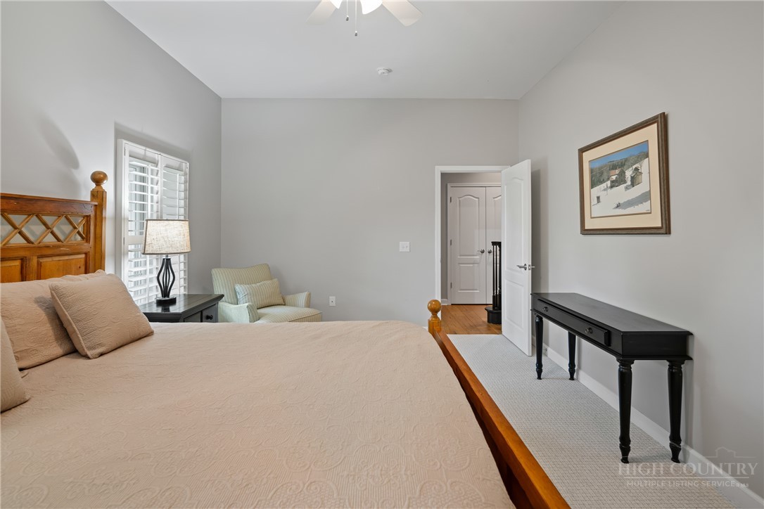 147 Riverside Park Court, Unit G2 Jefferson, NC 28640 - Photo 31 of 44 a bedroom with a bed and a lamp on table