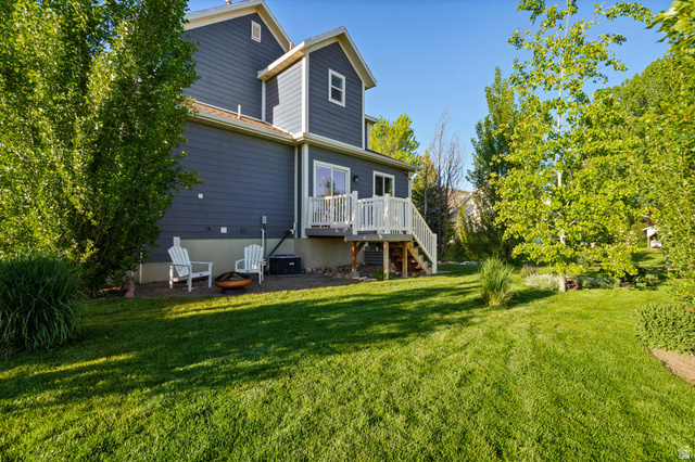 681 Island Road Morgan, UT 84050 - Photo 32 of 49 Expansive green lawn surrounds the property, featuring mature trees and landscaping