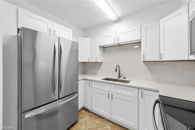 a kitchen with stainless steel appliances a refrigerator and cabinets