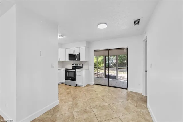 a kitchen with stainless steel appliances a refrigerator and a stove top oven