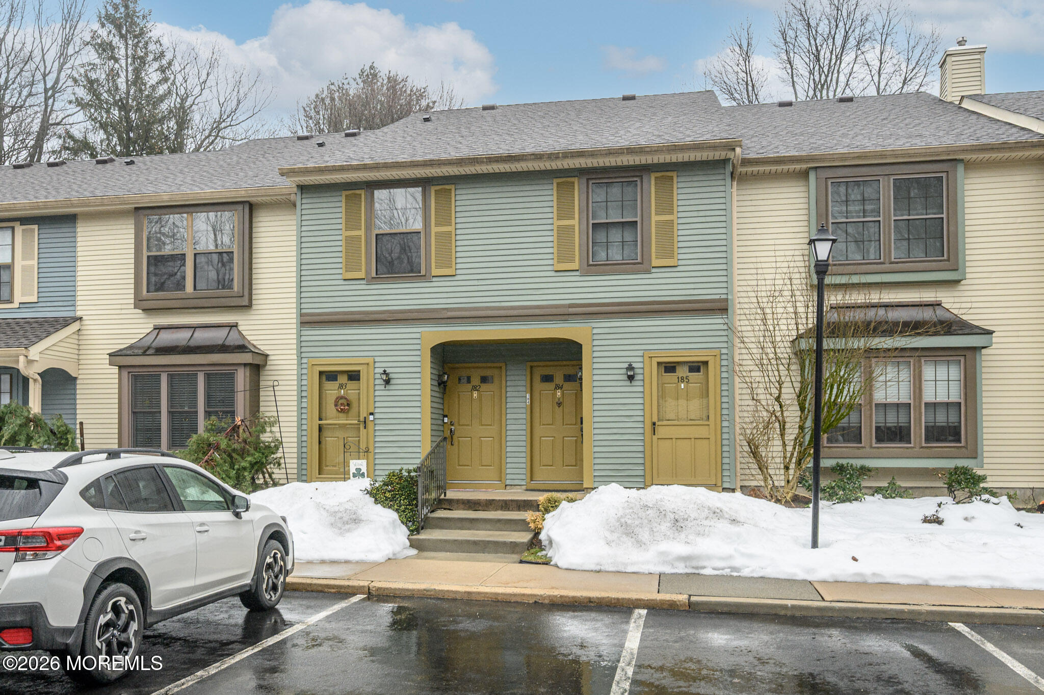 182 Edinburgh Court Matawan, NJ 07747 - Photo 1 of 24 a view of a white house with large windows and couches