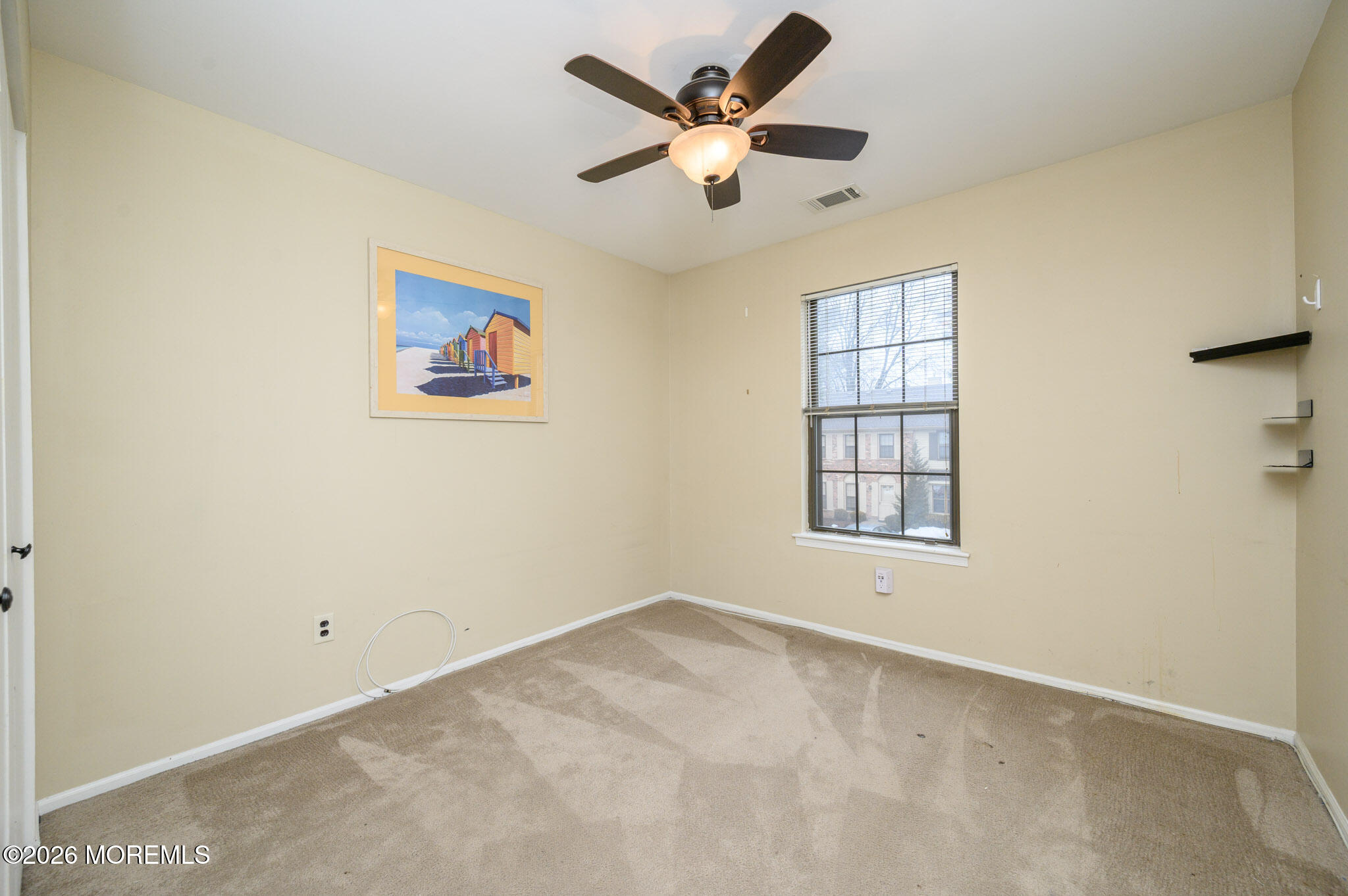 182 Edinburgh Court Matawan, NJ 07747 - Photo 15 of 24 an empty room with a ceiling fan and a window