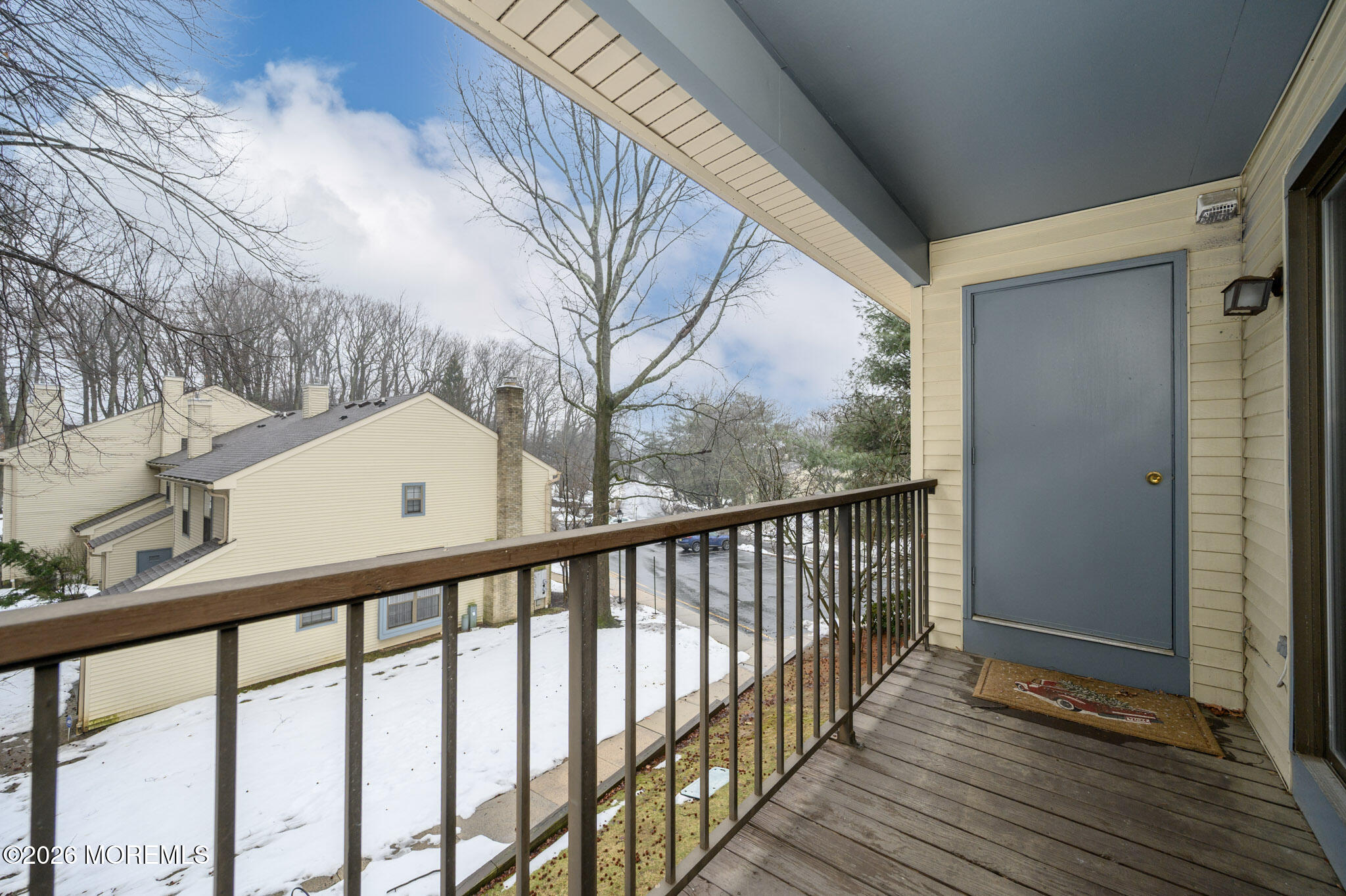 182 Edinburgh Court Matawan, NJ 07747 - Photo 22 of 24 a view of balcony with wooden floor and fence