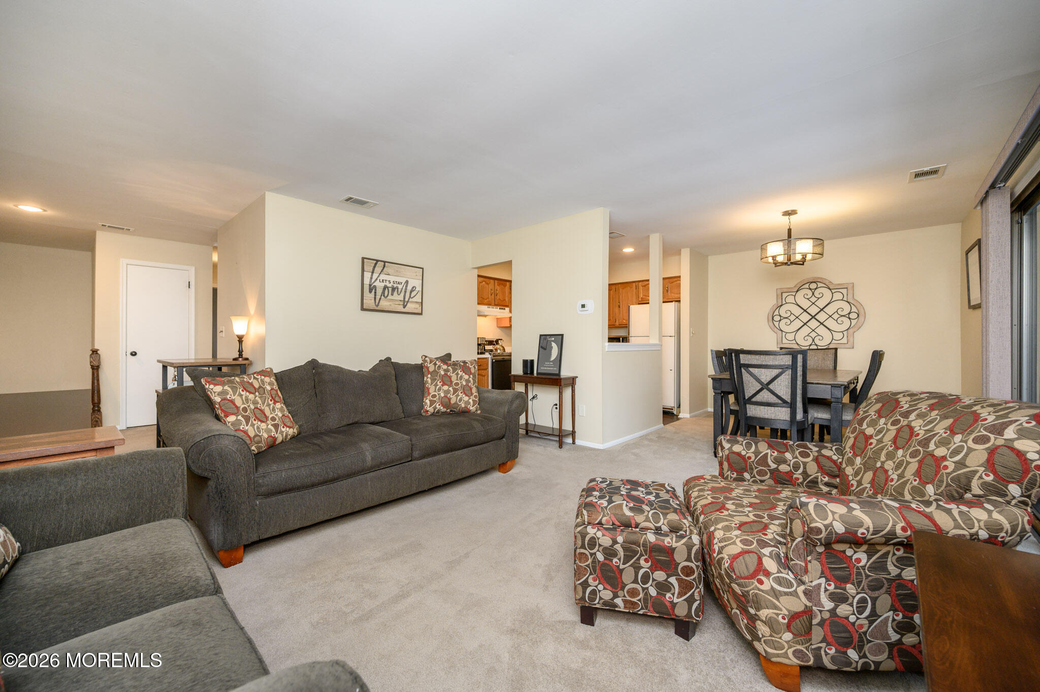 182 Edinburgh Court Matawan, NJ 07747 - Photo 7 of 24 a living room with furniture and a chandelier