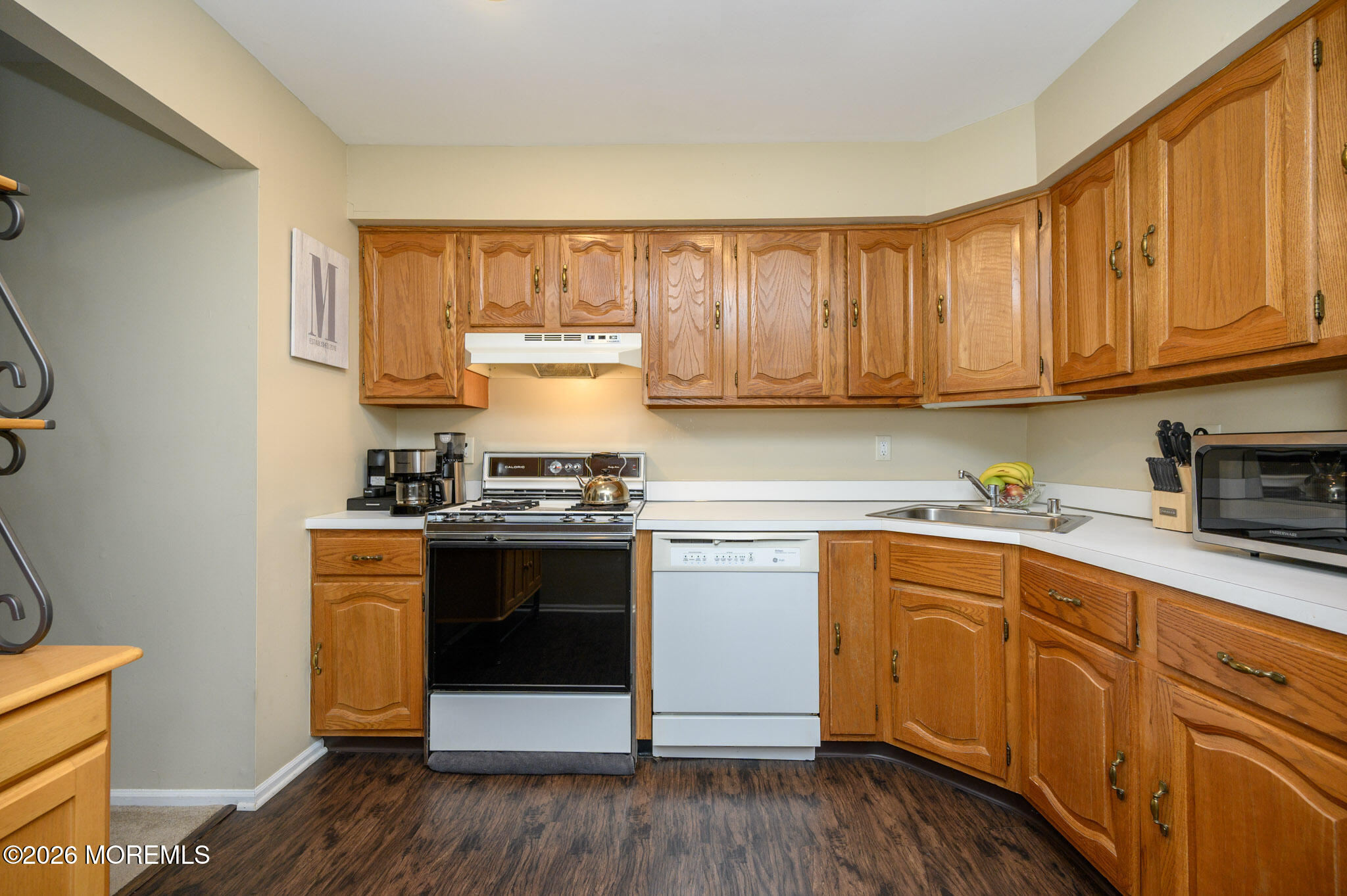 182 Edinburgh Court Matawan, NJ 07747 - Photo 10 of 24 a kitchen with stainless steel appliances granite countertop a stove and white cabinets