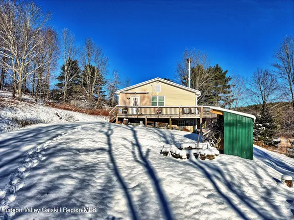 a view of a house with wooden fence