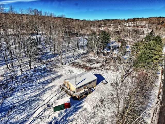 a kitchen with stainless steel appliances granite countertop a kitchen island a table chairs and a refrigerator