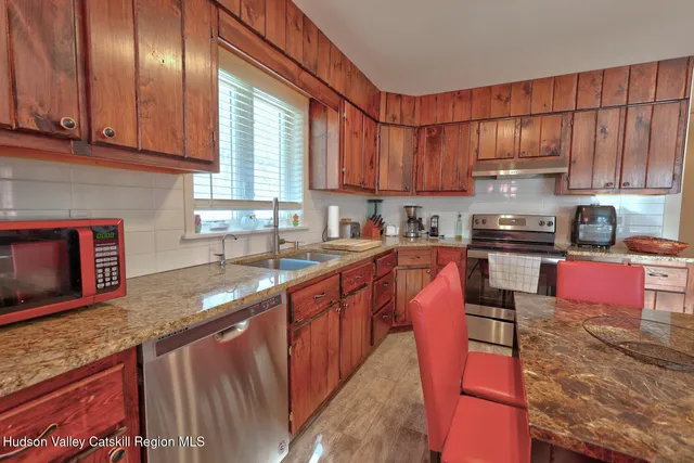 a living room with furniture a rug and a flat screen tv
