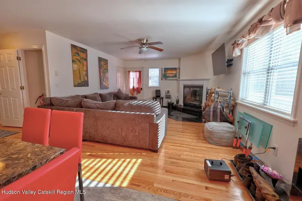 a living room with furniture a ceiling fan and a window