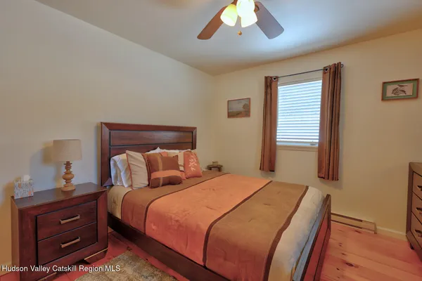 a bedroom with a bed and a night stand