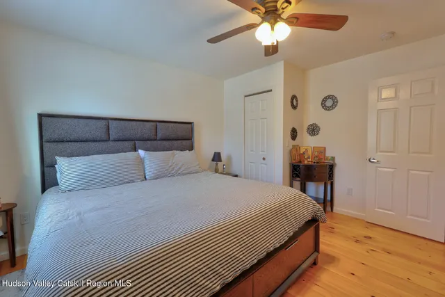 a living room with furniture a pool table and a wooden floor