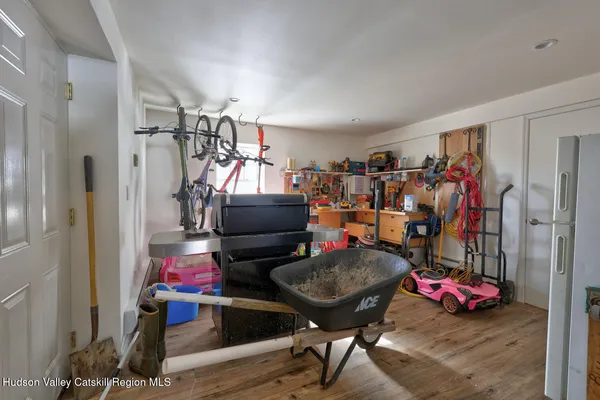 a living room with furniture a dining table and a wooden floor