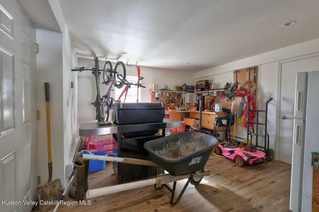 a living room with furniture a dining table and a wooden floor
