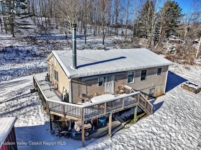 a roof deck with a table and chairs