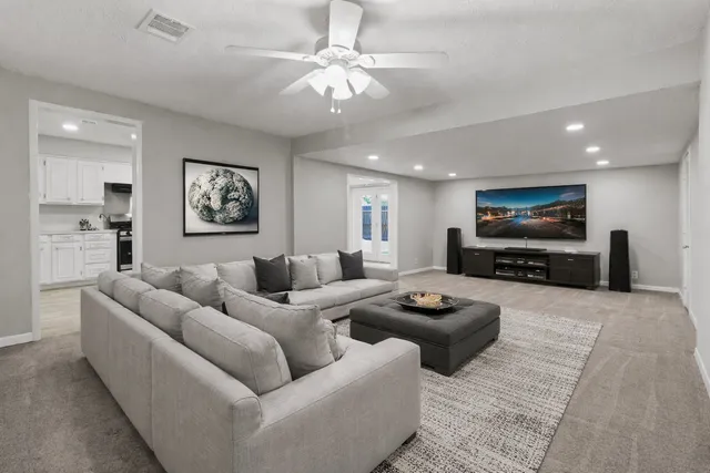 an empty room with fan and windows