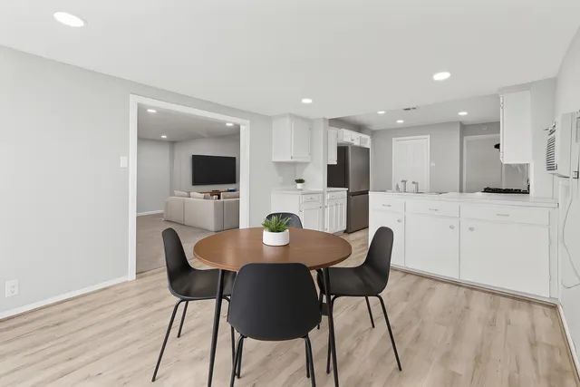 a kitchen with white cabinets stainless steel appliances and kitchen island